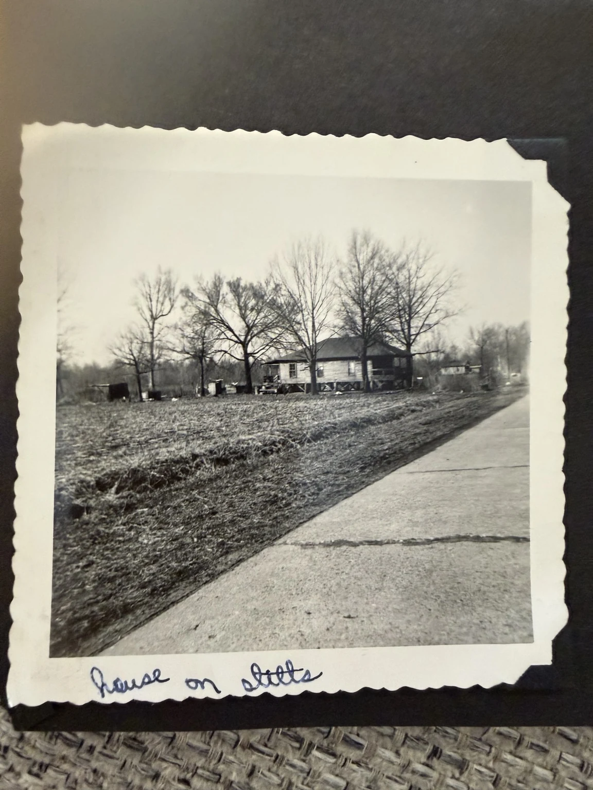 “house on stilts” (original caption). A roadside house; exact location, ownership and date are unconfirmed.