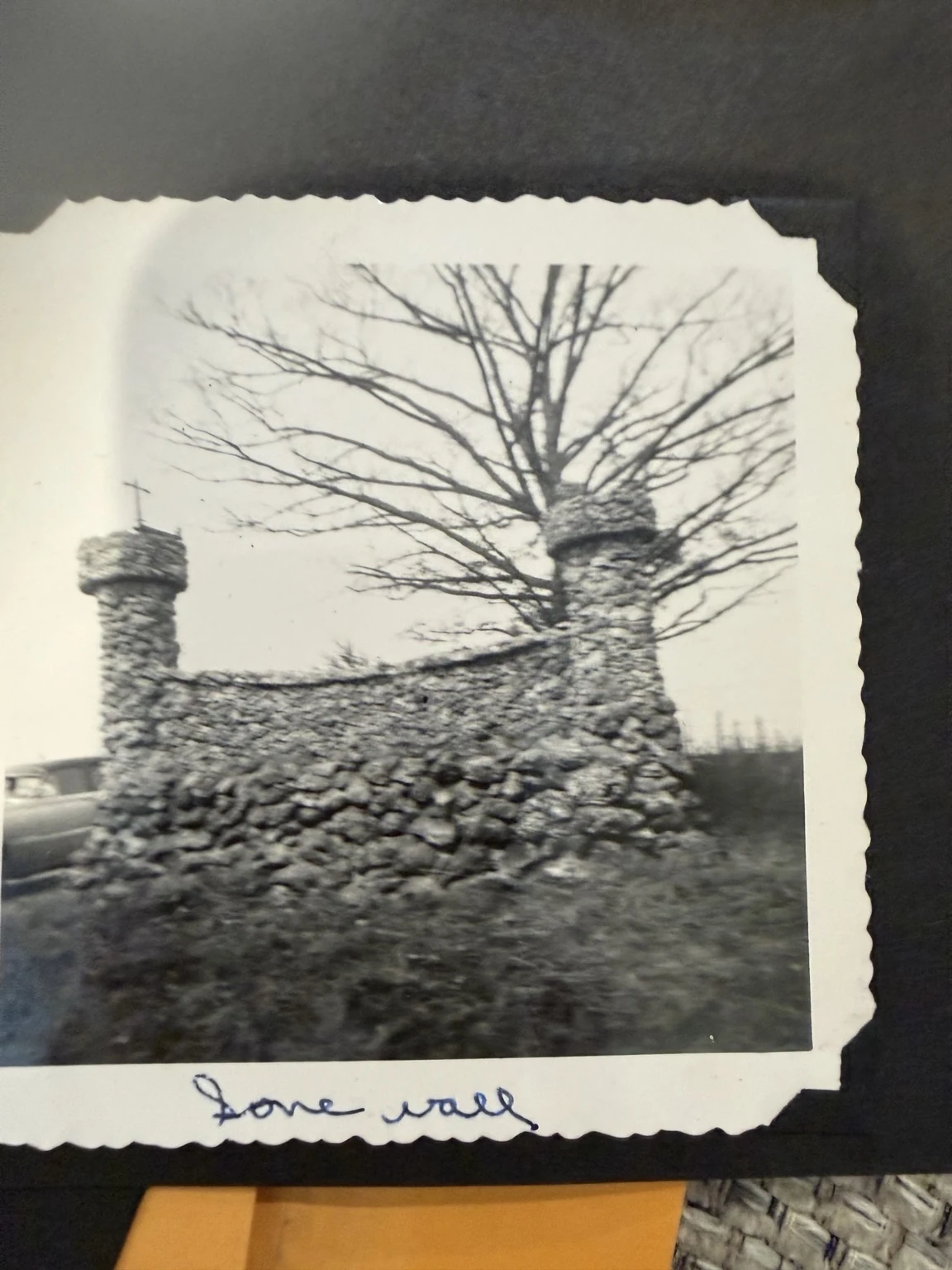 “Stone wall” (original caption). A curved stone wall and chimney-like structure. Exact place and date are unconfirmed.