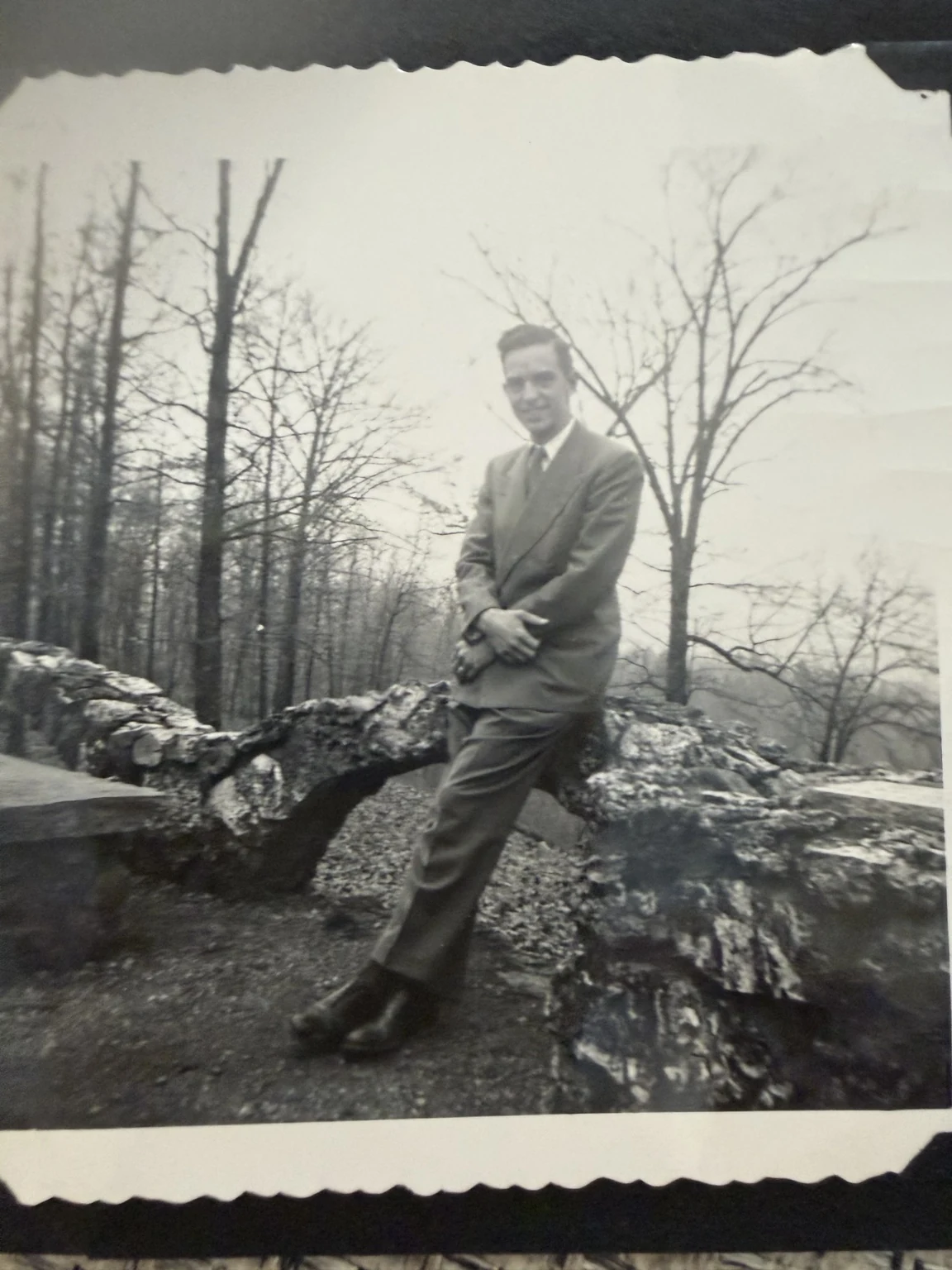 Bob, identified in the family collection, beside a low rock wall. Exact place and date are unconfirmed.