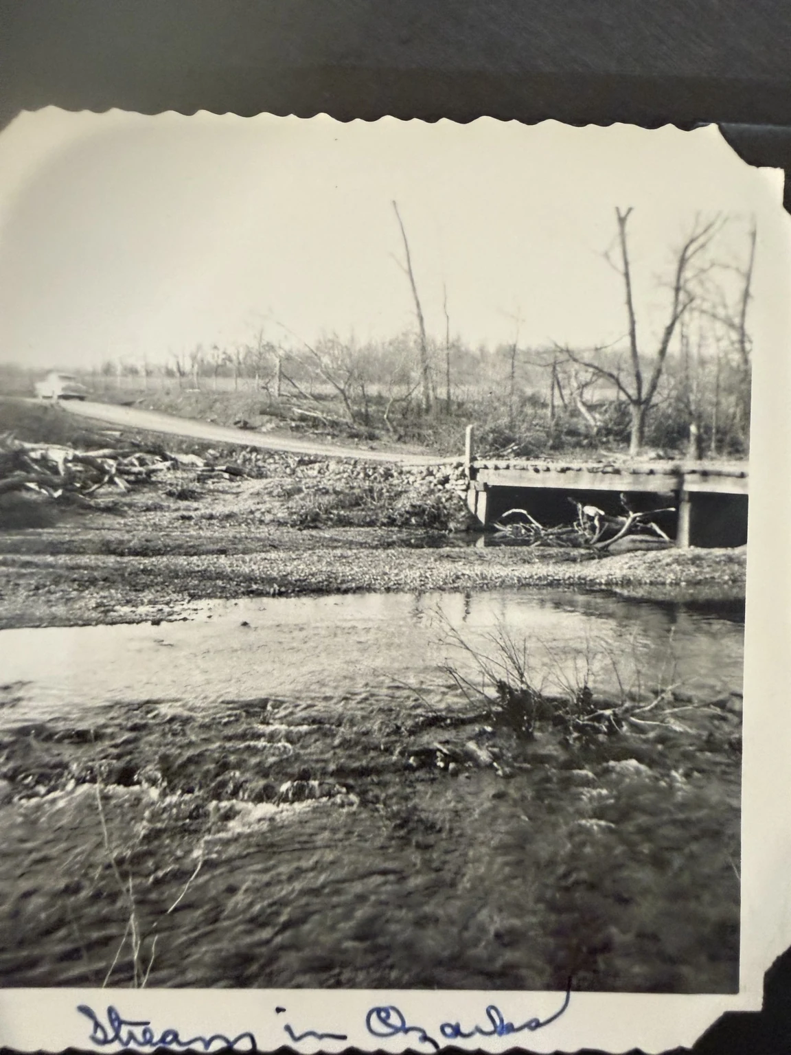 “Stream in Ozarks” (original caption). A stream and bridge. Exact waterway and date are unconfirmed.