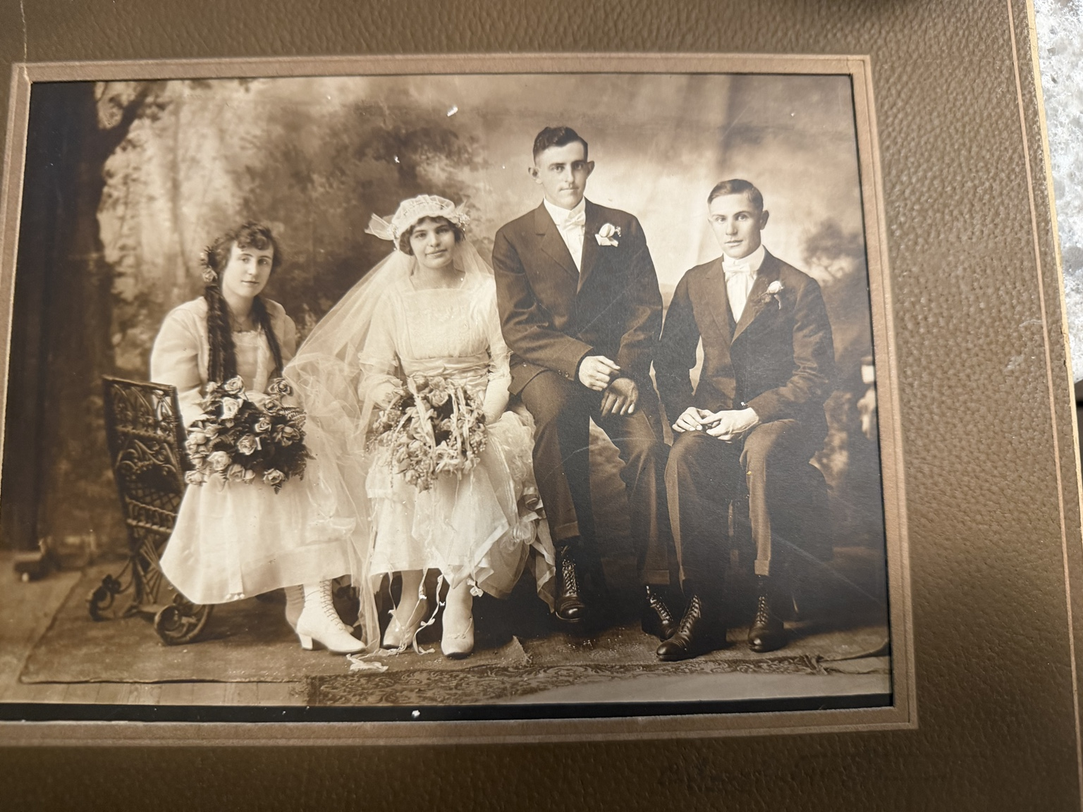 Four members of the 1917 Roling–Bange wedding party posed in a studio.