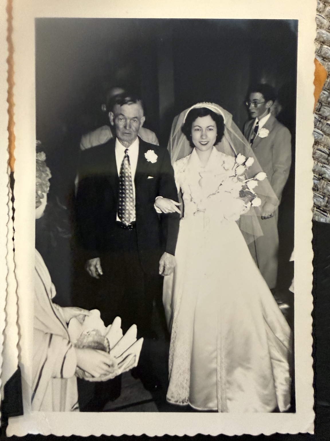The bride arm in arm with an unidentified man, with other people behind them.